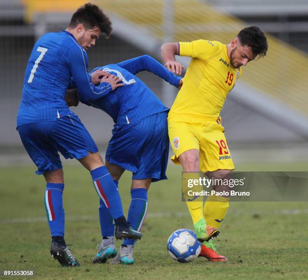 Gabriele Ferrarini and Lorenzo Gavioli of Italy U18 compete for the ball with Nandor Tamas of Romania U18 during the international friendly match...