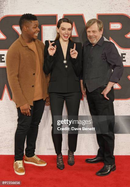 John Boyega, Daisy Ridley and Mark Hamill pose at the 'Star Wars: The Last Jedi' photocall at Corinthia Hotel London on December 13, 2017 in London,...