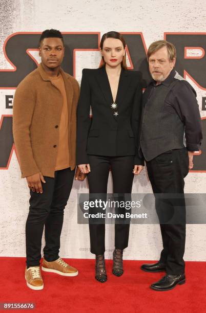 John Boyega, Daisy Ridley and Mark Hamill pose at the 'Star Wars: The Last Jedi' photocall at Corinthia Hotel London on December 13, 2017 in London,...