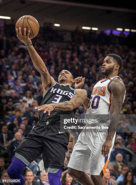 Sacramento Kings guard George Hill goes to the basket against the Phoenix Suns guard Troy Daniels on Tuesday, Dec. 12 at the Golden 1 Center in...