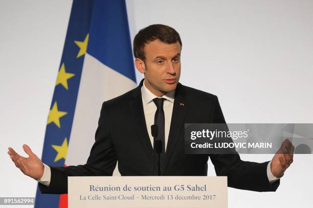 France's President Emmanuel Macron speaks during a press conference on December 13, 2017 at La Celle-Saint-Cloud, near Paris, during a summit from...