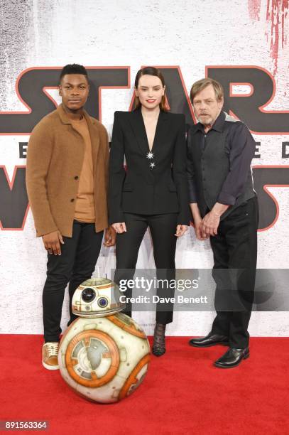 John Boyega, Daisy Ridley and Mark Hamill pose at the 'Star Wars: The Last Jedi' photocall at Corinthia Hotel London on December 13, 2017 in London,...