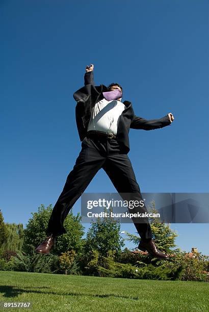 businessman jumping in air raising arms, zekeriyak&#246;y, istanbul, turkey - many hands in air stock pictures, royalty-free photos & images