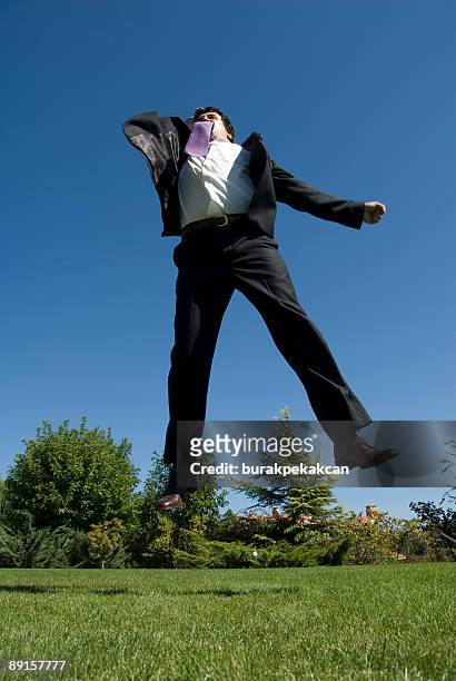 businessman jumping in air raising arms, turkey, istanbul, zekeriyak&#246;y - many hands in air stock pictures, royalty-free photos & images