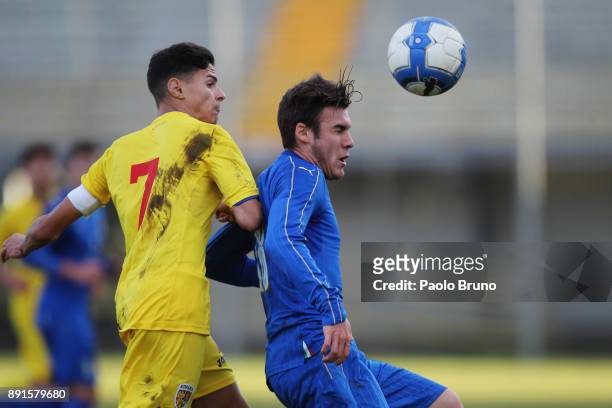 Elia Visconti of Italy U18 competes for the ball with Alexandru Tirlea of Romania U18 during the international friendly match between Italy U18 and...