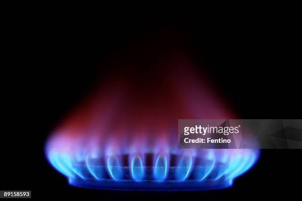 gas stove from side  (blue flames on black) - stove stock pictures, royalty-free photos & images