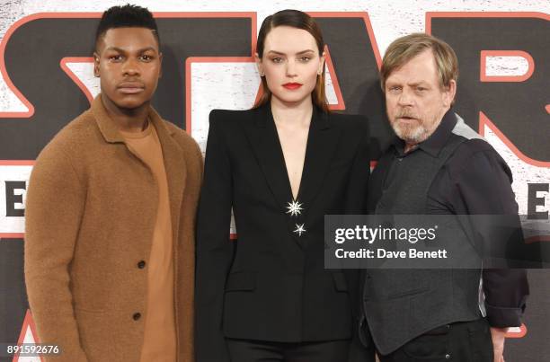 John Boyega, Daisy Ridley and Mark Hamill pose at the 'Star Wars: The Last Jedi' photocall at Corinthia Hotel London on December 13, 2017 in London,...