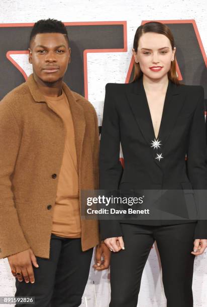 John Boyega and Daisy Ridley pose at the 'Star Wars: The Last Jedi' photocall at Corinthia Hotel London on December 13, 2017 in London, England.