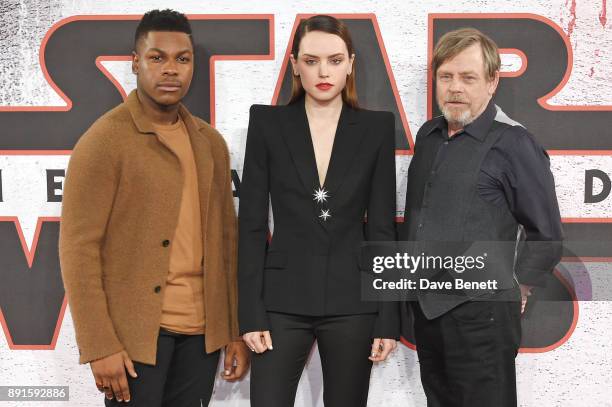 John Boyega, Daisy Ridley and Mark Hamill pose at the 'Star Wars: The Last Jedi' photocall at Corinthia Hotel London on December 13, 2017 in London,...