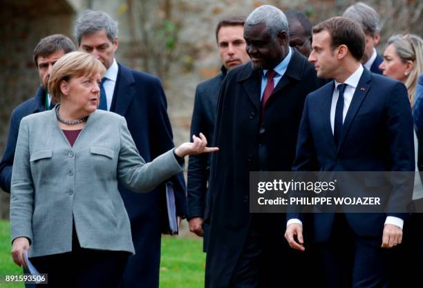 German Chancellor Angela Merkel , France's President Emmanuel Macron and Chairperson of the African Union Commission Moussa Faki Mahamat arrive for a...