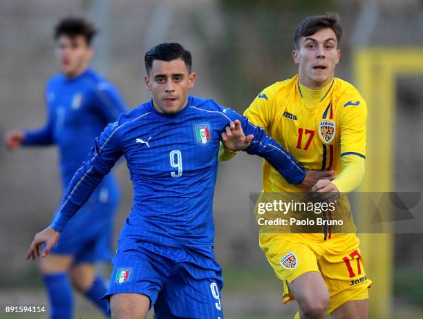 Davide Merola of Italy U18 competes for the ball with Marian Serbian of Romania U18 during the international friendly match between Italy U18 and...