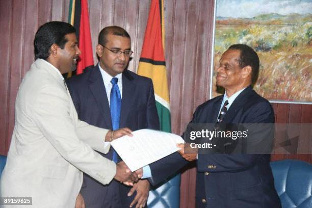 West Indies Players Association President Dinanath Ramnarine shakes hands with West Indies Cricket Board President Julian Hunte during a meeting...