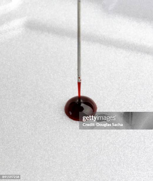 drop of blood sample on a testing strip - liquid solution stock pictures, royalty-free photos & images