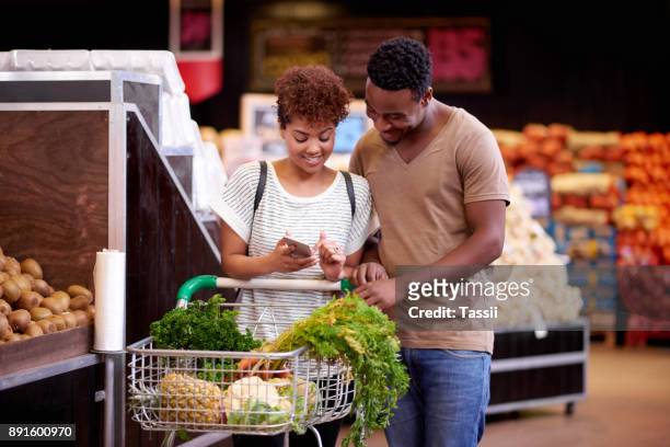 ensuring they stay on track with their shopping budget - french food market stock pictures, royalty-free photos & images
