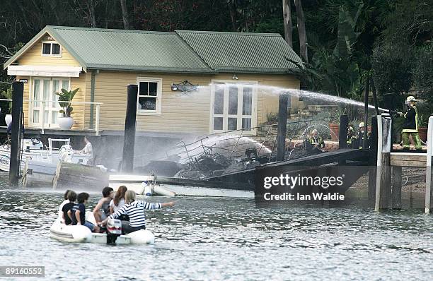 The remains of motorcruisers blaze at Sirsi Marina on July 22, 2009 on Pittwater at Newport on Sydney's Northern Beaches, Australia. At least five...