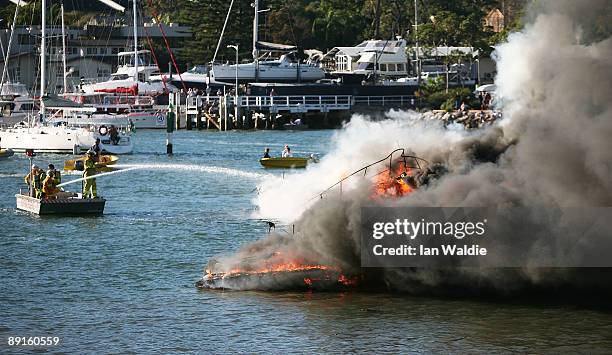 The remains of motorcruisers blaze at Sirsi Marina on July 22, 2009 on Pittwater at Newport on Sydney's Northern Beaches, Australia. At least five...