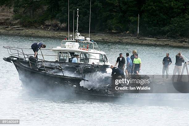 The remains of motorcruisers blaze at Sirsi Marina on July 22, 2009 on Pittwater at Newport on Sydney's Northern Beaches, Australia. At least five...