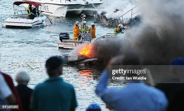 The remains of motorcruisers blaze at Sirsi Marina on July 22, 2009 on Pittwater at Newport on Sydney's Northern Beaches, Australia. At least five...