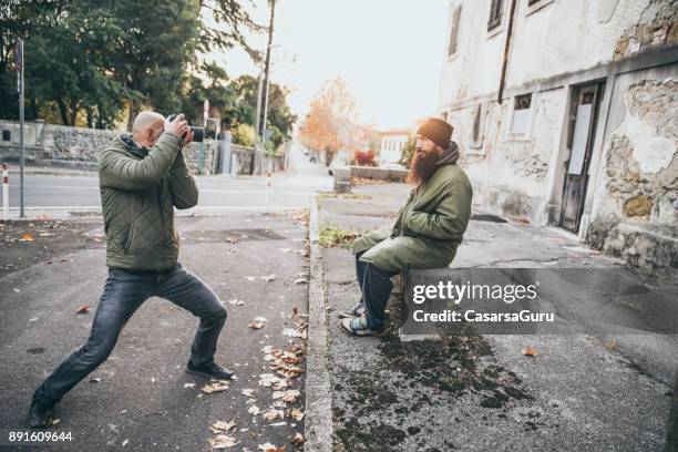 photographer photographing adult homeless man - artists model stock pictures, royalty-free photos & images