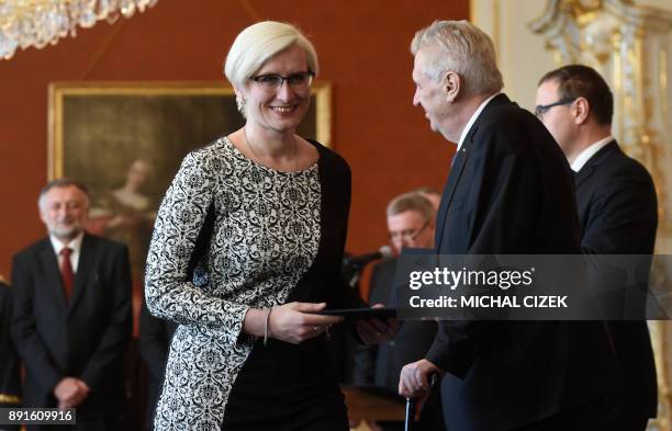 The new Czech Defence Minister Karla Slechtova of the ANO party smiles next to Czech President Milos Zeman after she was appointed on December 13,...