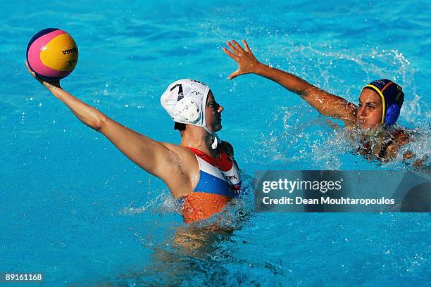 Iefke van Belkum of Netherlands shoots on goal in front of Christina Lopez of Spain in the Women's Water Polo during 13th FINA World Championships at...