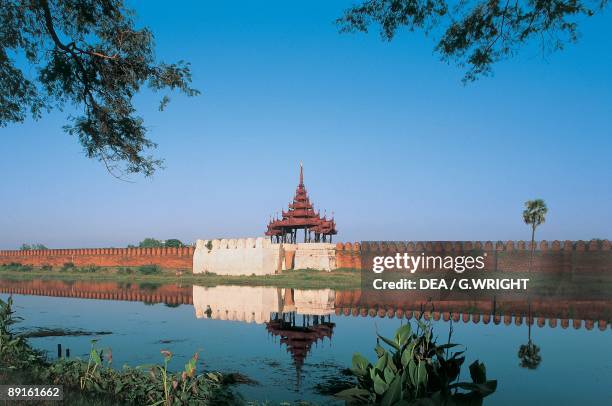 Reflection of the wall of a royal palace in water, Mandalay, Myanmar