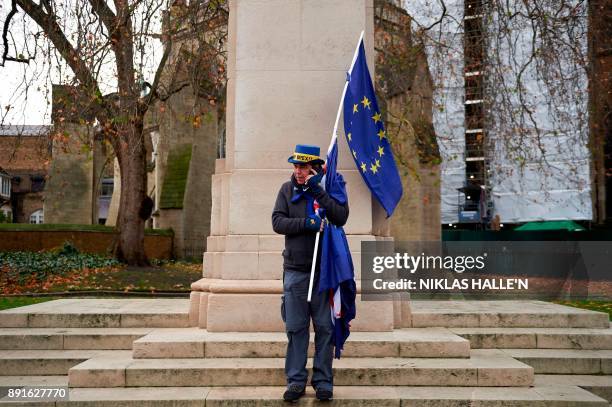 Pro-EU, anti-Brexit demonstrator Steve Bray wrapped in an EU flag joins a protest outside the Houses of Parliament in central London on December 13,...