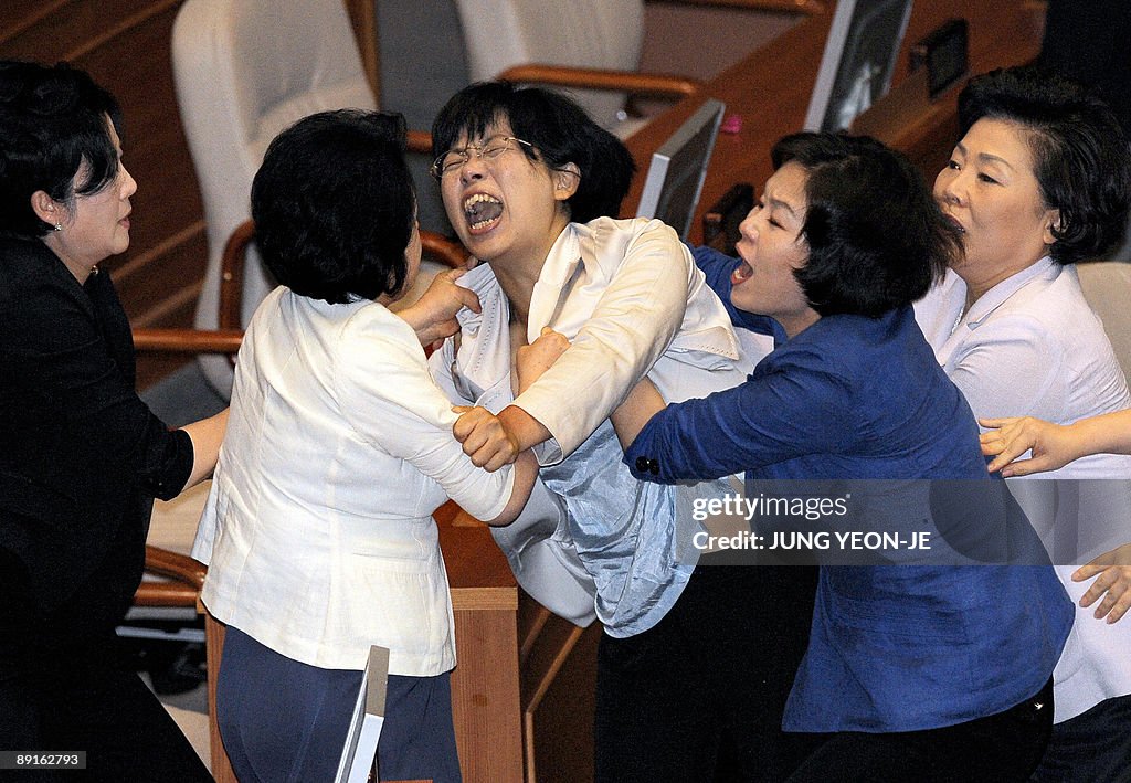 A female opposition legislator screams a