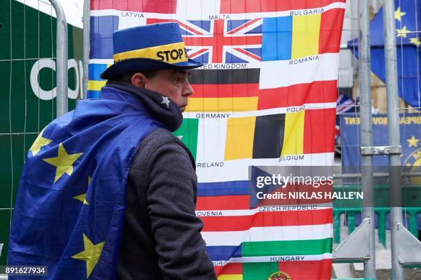 Pro-EU, anti-Brexit demonstrator Steve Bray wrapped in an EU flag joins a protest outside the Houses of Parliament in central London on December 13,...