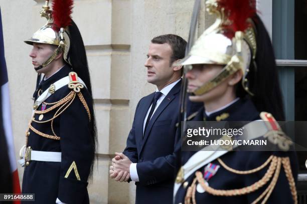 French president Emmanuel Macron stands at the entrance of the castle of la Celle Saint cloud for a summit from the underfunded G5 Sahel anti-terror...