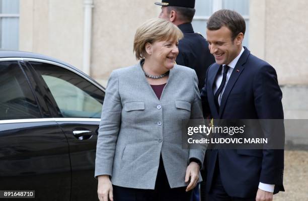 German chancellor Angela Merkel is welcomed by French President Emmanuel Macron upon at his arrival for a summit from the underfunded G5 Sahel...