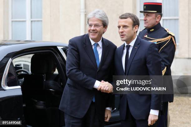 Italian president of the minister council Paolo Gentiloni is welcomed by French President Emmanuel Macron upon at his arrival for a summit from the...