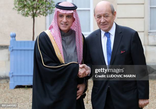 Saudi foreign affairs minister Adel Al Jubeir is welcomed by French foreign affairs minister Jean Yves Le Drian upon his arrival for a summit from...