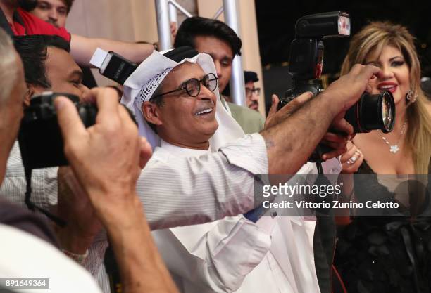 Chairman Abdulhamid Juma joins the photographers at the "Star Wars: The Last Jedi" Closing Night red carpet on day eight of the 14th annual Dubai...