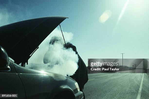 woman checking smoking hood of car - vehicle breakdown bildbanksfoton och bilder