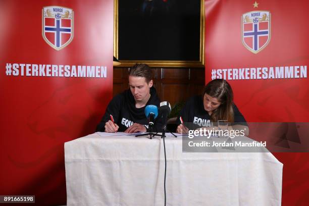 Stefan Johansen and Maren Mjelde sign the agreement during the Football Association of Norway National Team Equal Pay Agreement Announcement at the...