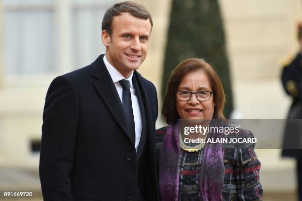 French President Emmanuel Macron greets President of Marshall Islands Hilda Heine upon her arrival at the Elysee palace on December 12, 2017 in...