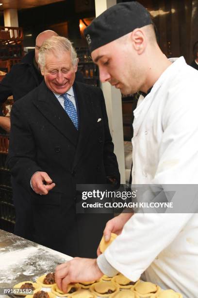 Britain's Prince Charles, Prince of Wales , and Britain's Camilla, Duchess of Cornwall speak to a baker on a visit to Borough Market in London on...