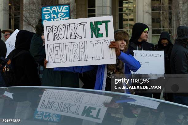 Demonstrator holds a 'Protect Net Neutrality' protest sign during a demonstration against the proposed repeal of net neutrality outside the Federal...