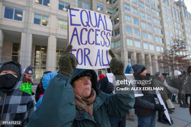 Woman holds an 'Equal Access For All' protest sign during a demonstration against the proposed repeal of net neutrality outside the Federal...