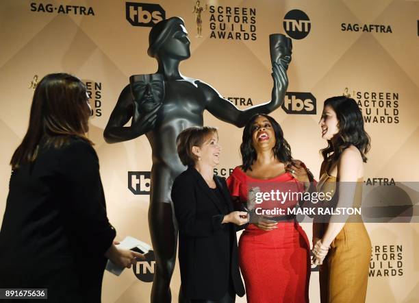 President Gabrielle Carteris , laughs with presenters Niecy Nash and Olivia Munn on stage during the 24th Annual Screen Actors Guild Awards...