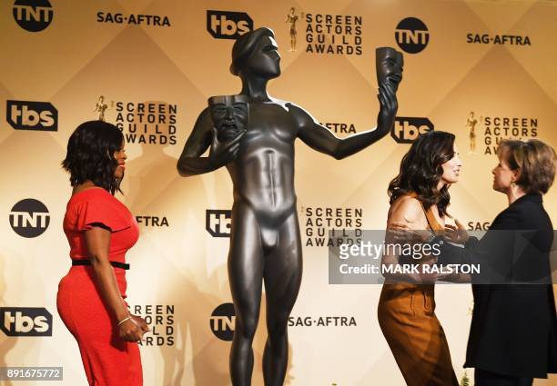 President Gabrielle Carteris , laughs with presenters Niecy Nash and Olivia Munn on stage during the 24th Annual Screen Actors Guild Awards...