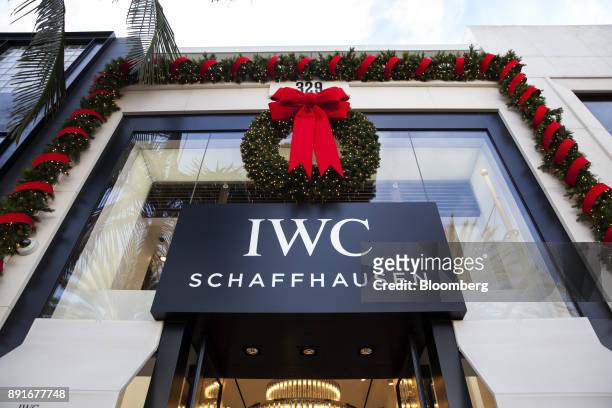Christmas wreath hangs on display above signage at the IWC International Watch Co. AG store on Rodeo Drive in Beverly Hills, California, U.S., on...