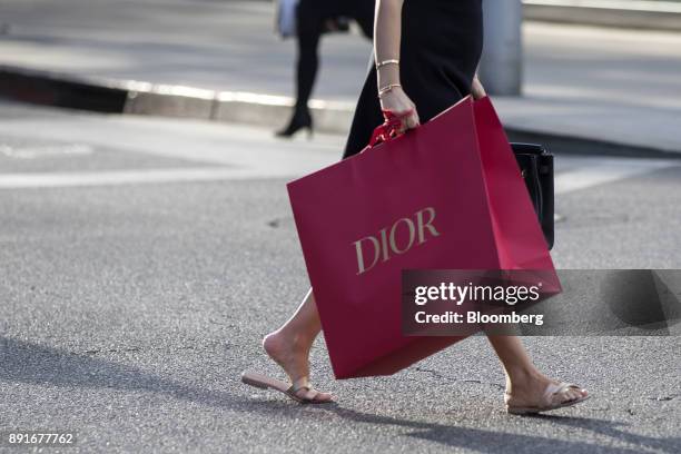 Shopper carries a Christian Dior SE bag on Rodeo Drive in Beverly Hills, California, U.S., on Saturday, Dec. 9, 2017. The U.S. Census Bureau is...