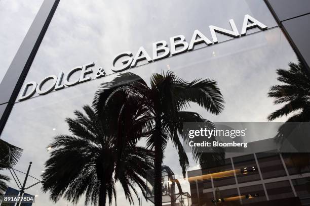 Palm trees are reflected in a window of the Dolce & Gabbana Srl store on Rodeo Drive in Beverly Hills, California, U.S., on Saturday, Dec. 9, 2017....