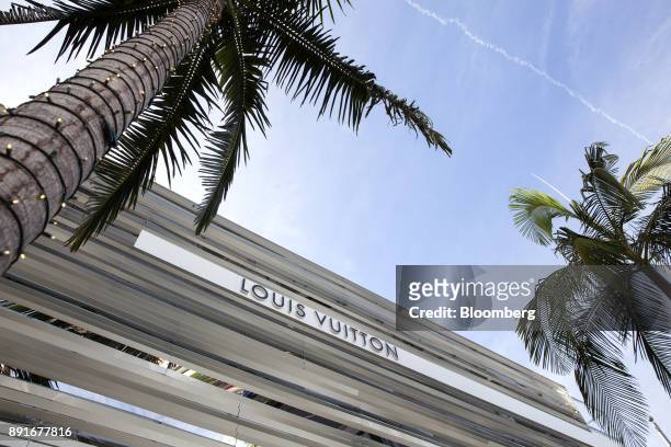 Palm tree wrapped in holiday lights stands outside a LVMH Moet Hennessy Louis Vuitton SE store on Rodeo Drive in Beverly Hills, California, U.S., on...