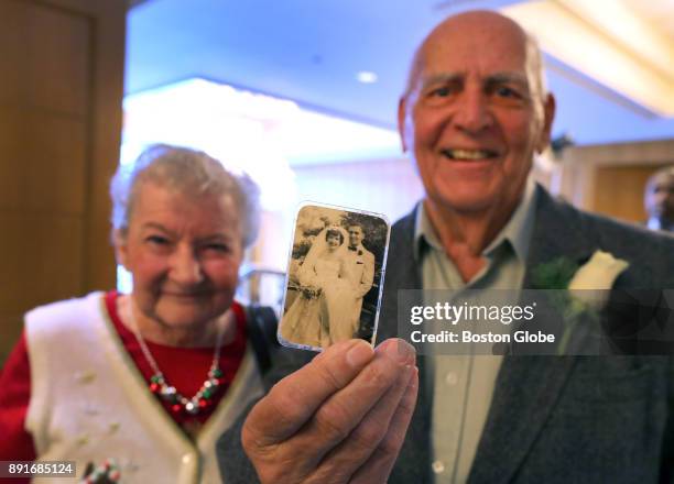 Roy Crawford shows the wedding photo taken in 1954 of him and his wife Mary, to whom he has been married for 63 years, at the annual Boston Elderly...