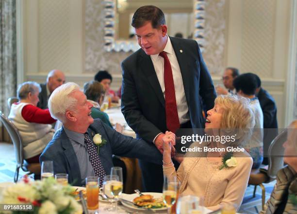 Boston Mayor Martin J. Walsh greets Bill and Ann Downey, who have been married for 60 years, during the annual Boston Elderly Commission Golden...