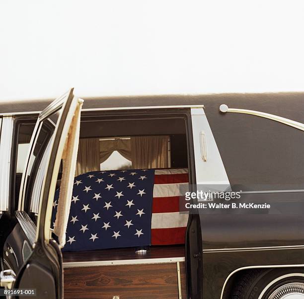 american flag draped over coffin in hearse - flag draped coffin stock pictures, royalty-free photos & images