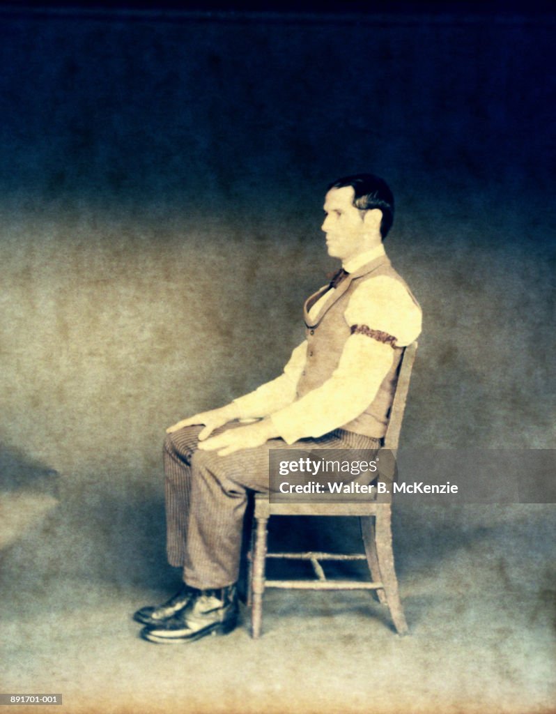 Man sitting on chair (paper negative)